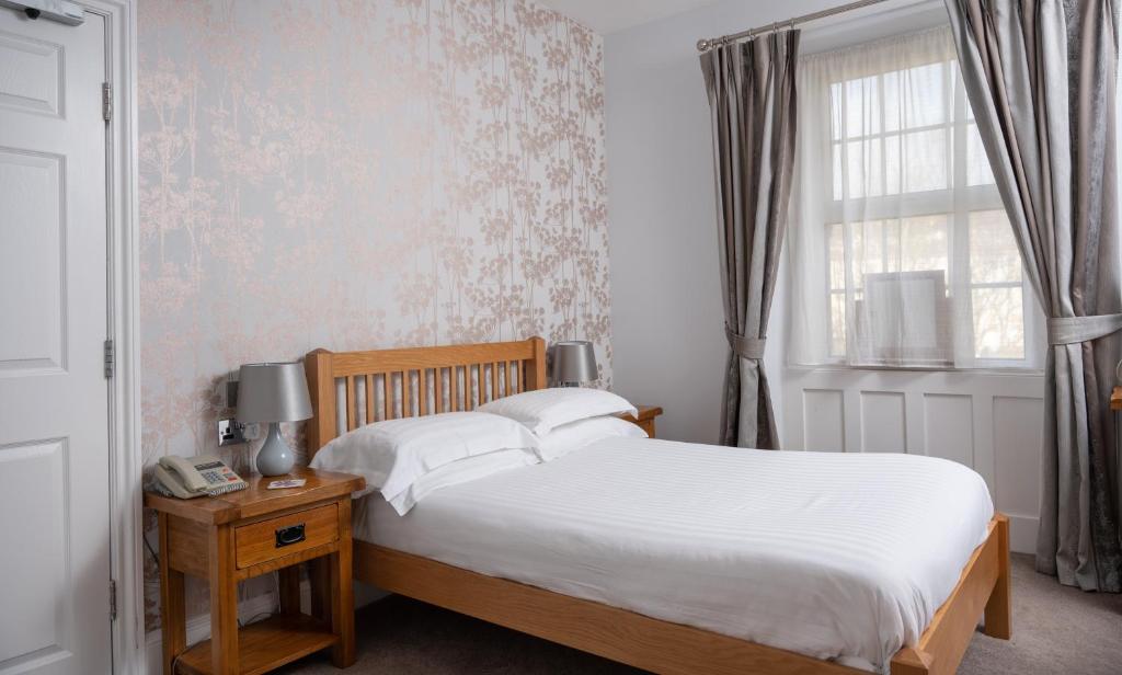 a bedroom with a bed and a window at Lauriston Hotel in Weston-super-Mare