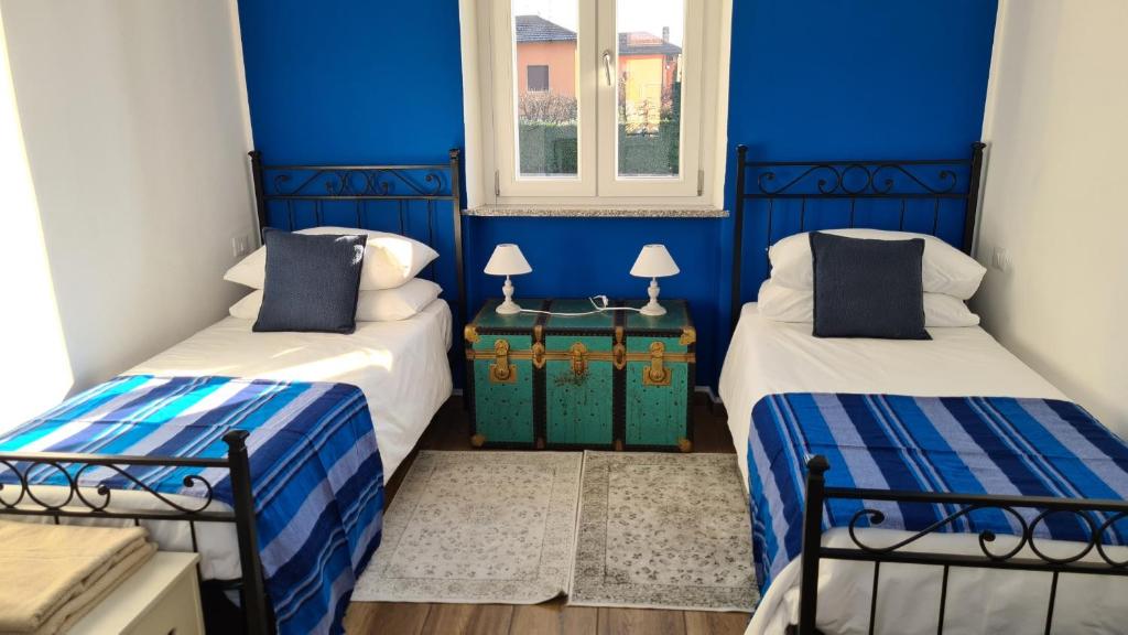 Postel nebo postele na pokoji v ubytování Dragonfly Appartamento Blu