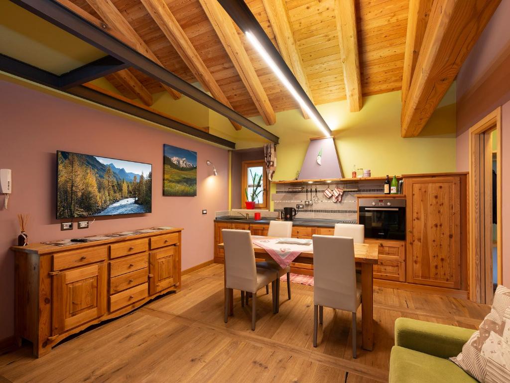 a kitchen with a table and a dining room at Agriturismo Gli Elfi in Aosta