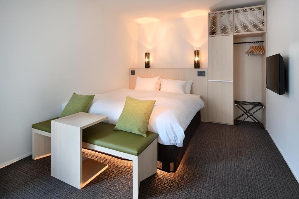 Postel nebo postele na pokoji v ubytování HOTEL KYOTOLOGY