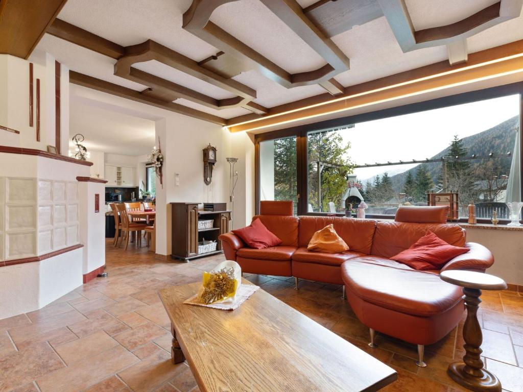 a living room with a couch and a table at Chalet in Mallnitz in Carinthia near ski area in Mallnitz