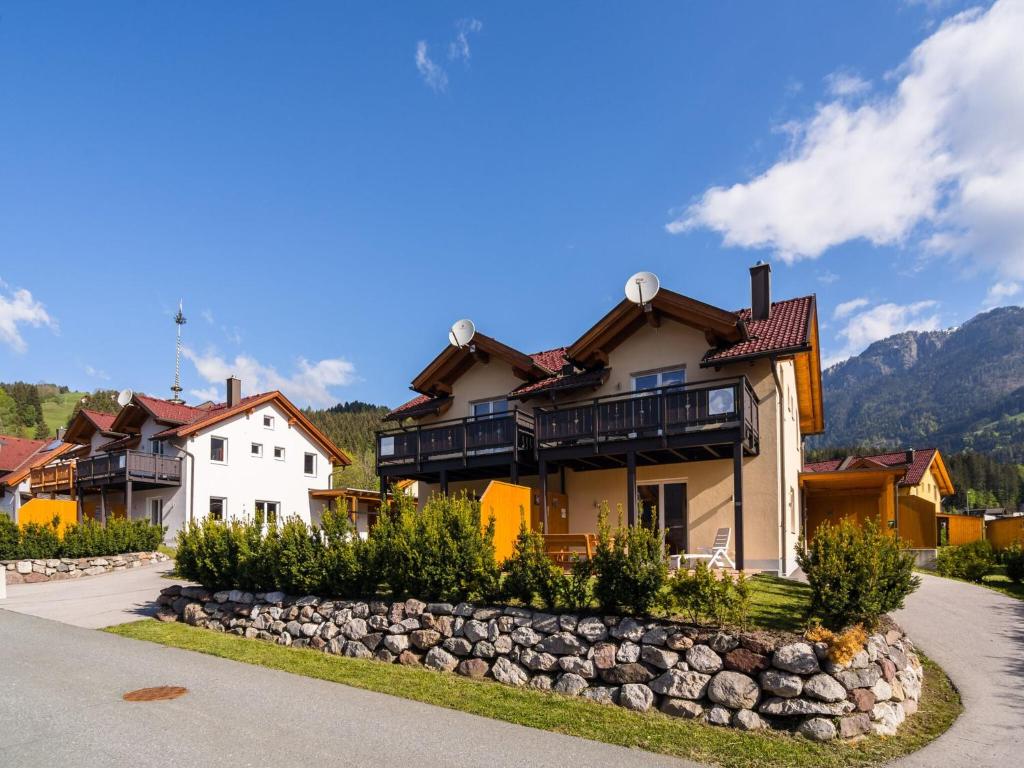 a house in a village with a stone wall at Chalet in Carinthia near ski area in Kötschach