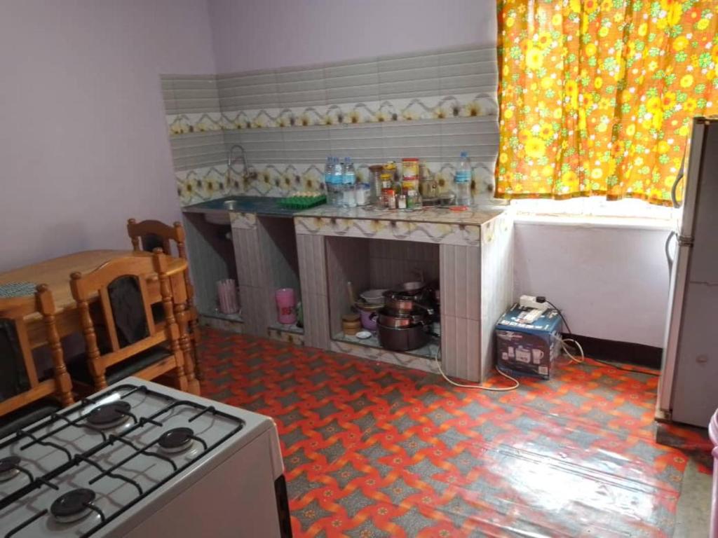 a kitchen with a stove and a counter top at Beautiful & Stylish 2-Bedroom Apartment in Karatu in Karatu