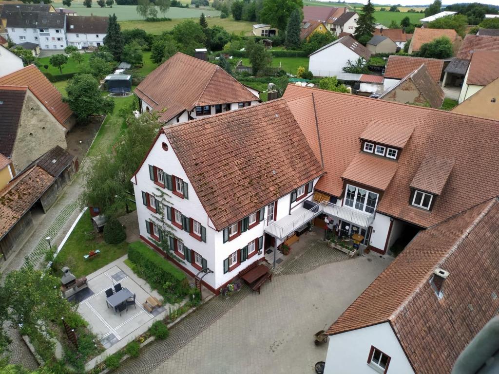 an overhead view of a large white house with red roofs at Ferienbauernhof Moarhof in Wittelshofen