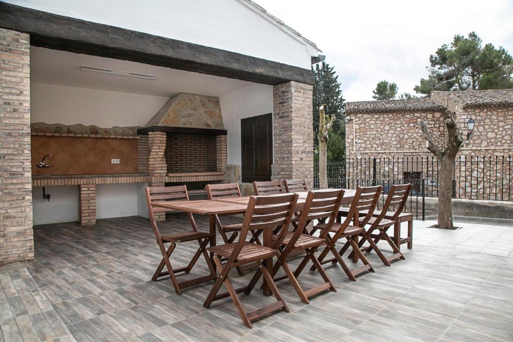 a wooden table and chairs on a patio at La Casa de Alarcón in Alarcón