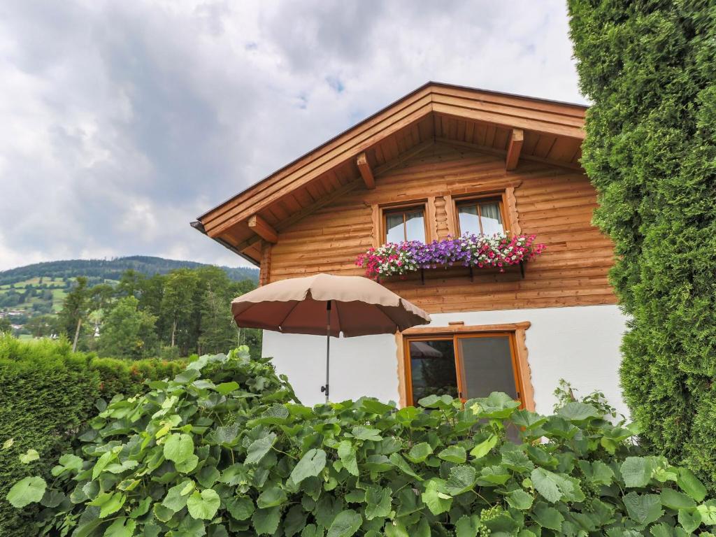 a house with an umbrella in front of it at Cosy holiday home near ski area in Piesendorf
