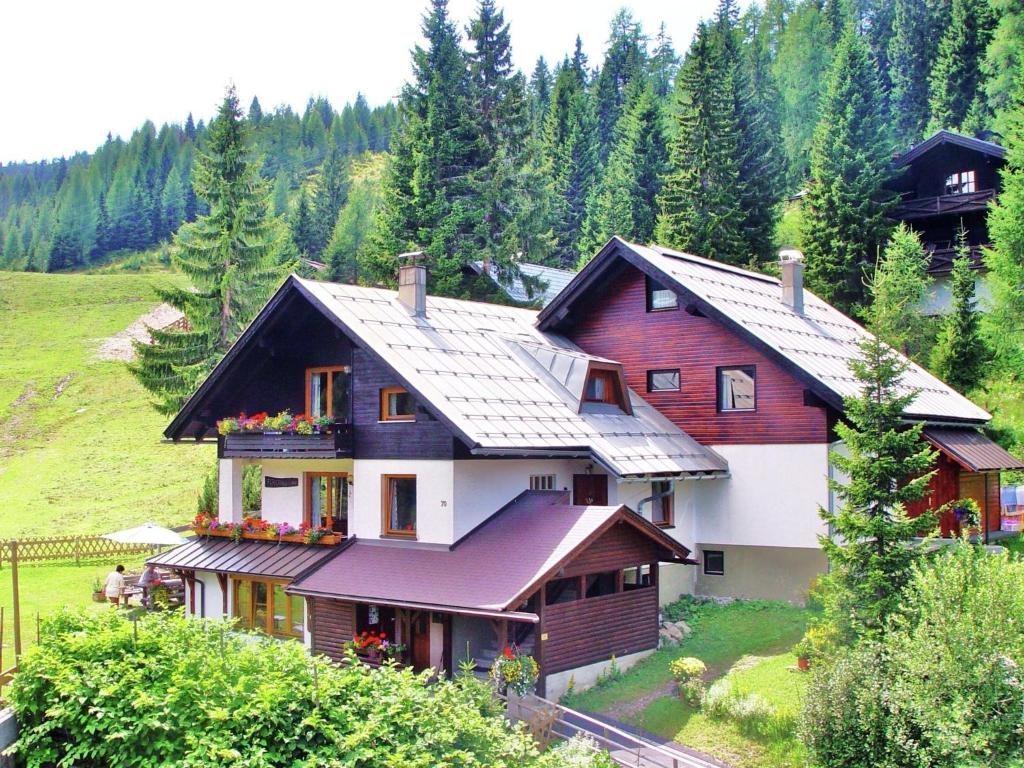 a house on top of a hill with trees at Apartment in Hermagor Pressegger See with sauna in Sonnenalpe Nassfeld