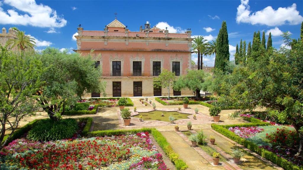 a large building with a garden in front of it at Hotel Trafalgar in Jerez de la Frontera