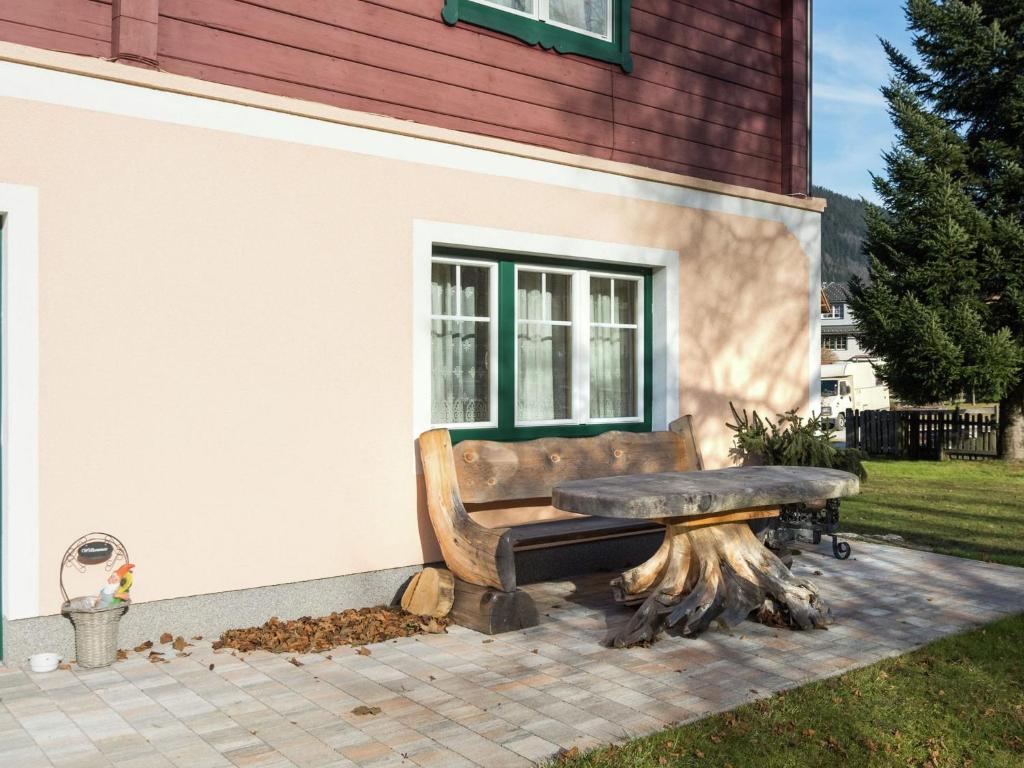 a bench sitting in front of a building at Renovated holiday home in the mountains in Pruggern