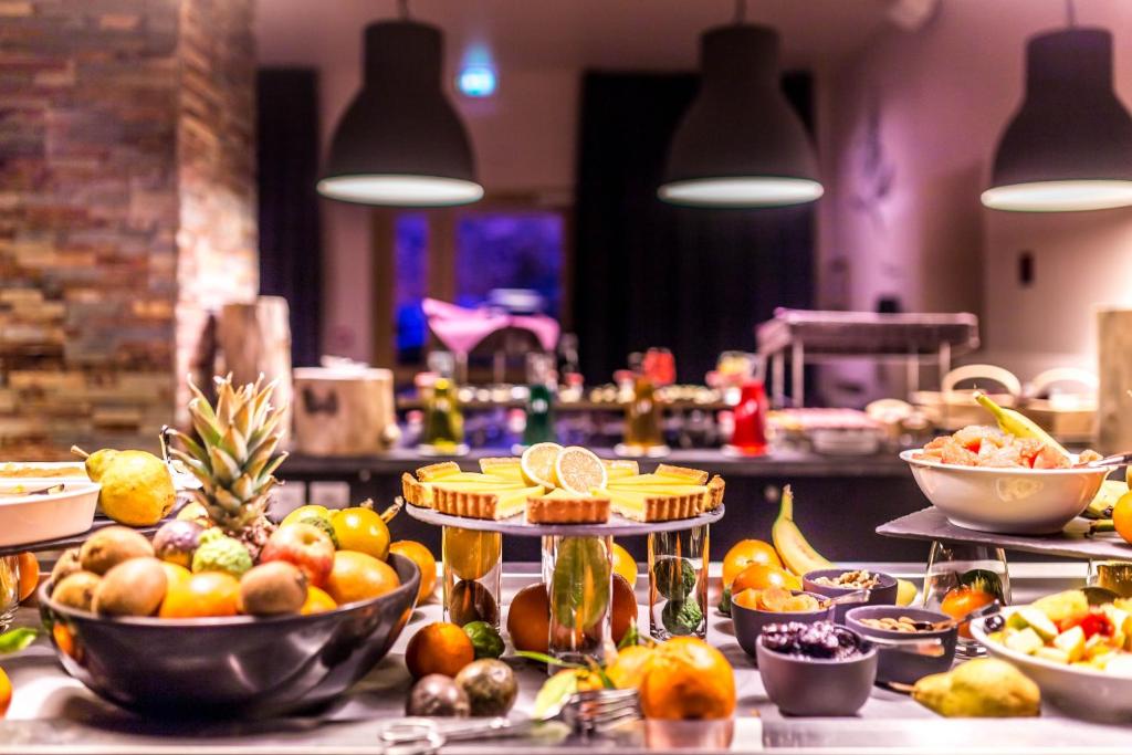 a buffet with fruits and vegetables on a table at Le Grand Aigle Hotel & Spa**** in La Salle-les-Alpes