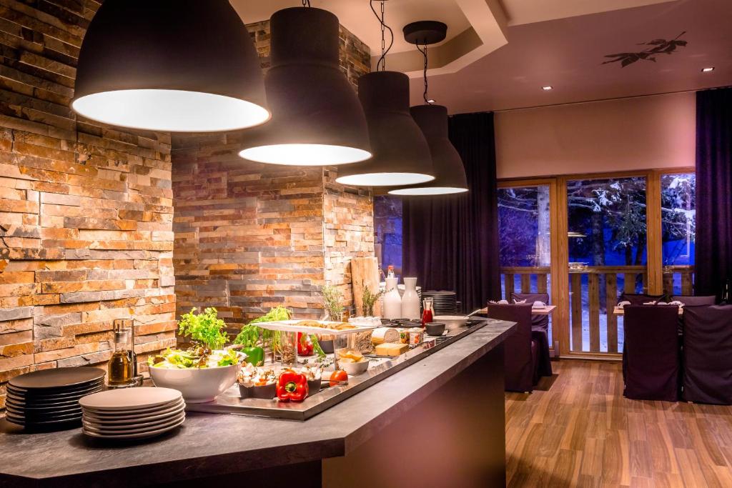a kitchen with a counter with food on it at Le Grand Aigle Hotel & Spa**** in La Salle-les-Alpes