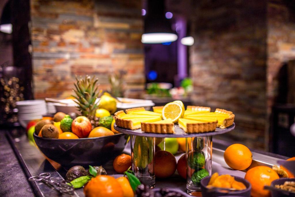 a buffet with a variety of fruits and snacks at Le Grand Aigle Hotel & Spa**** in La Salle-les-Alpes