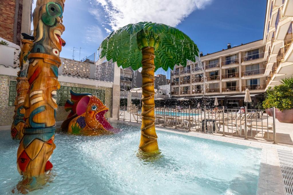 a palm tree in the water at a water park at Aparthotel Miami Park in Calella