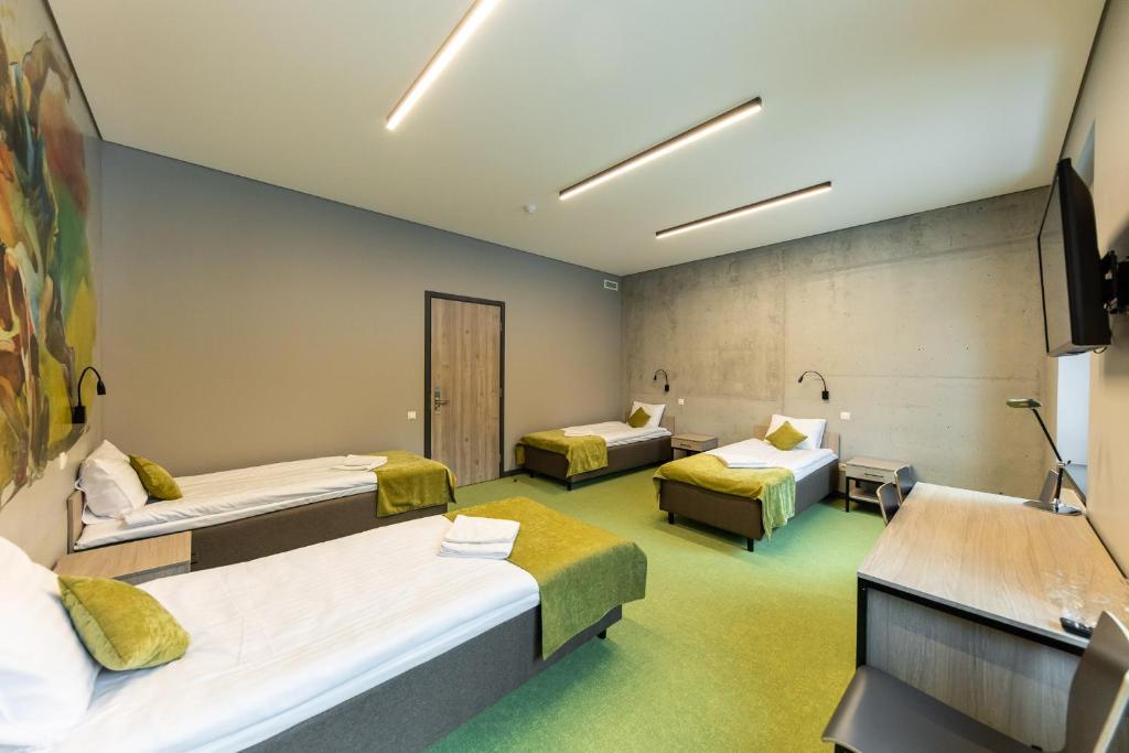 Postel nebo postele na pokoji v ubytování Stadium Hotel