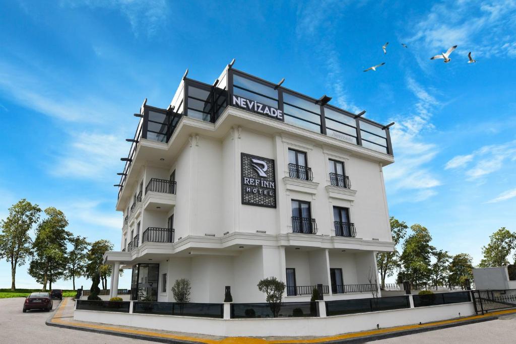 a white building with birds in the sky at REF İNN HOTEL in Ordu