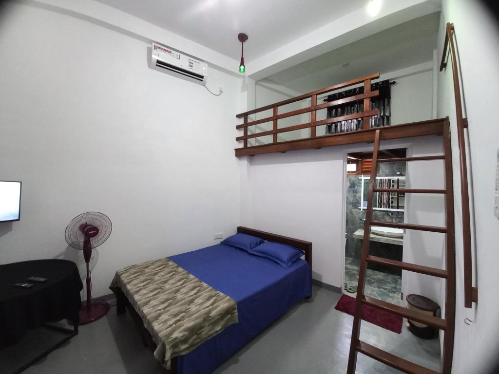 a bedroom with a bunk bed and a ladder at Star Guest in Balangoda