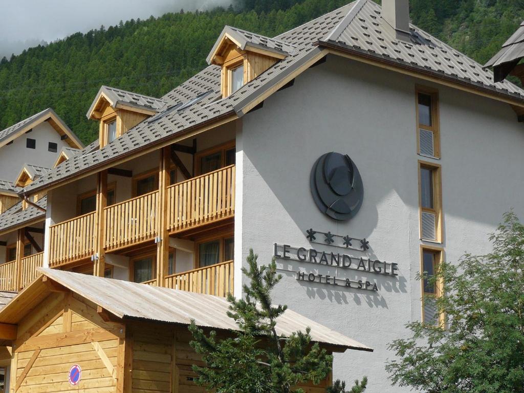 a building with a sign for the enchanted ridge hotel at Le Grand Aigle Hotel & Spa**** in La Salle-les-Alpes