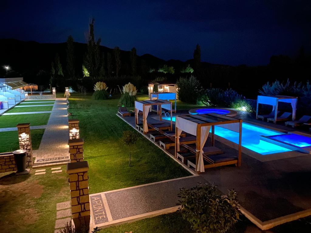 a backyard with a pool at night at A Ponte Studios & Apartments in Sykia Chalkidikis