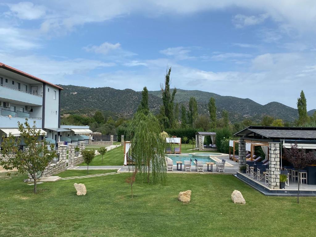 a resort with a swimming pool and a building at A Ponte Studios & Apartments in Sykia Chalkidikis