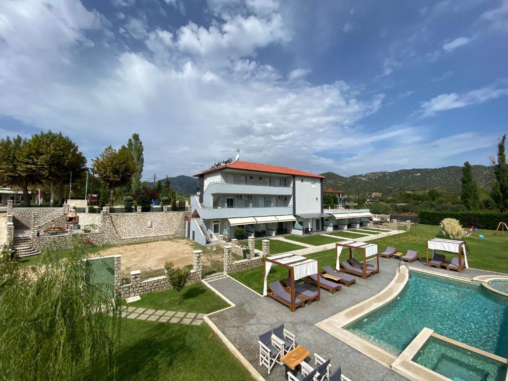 a villa with a swimming pool and a house at A Ponte Studios & Apartments in Sykia Chalkidikis