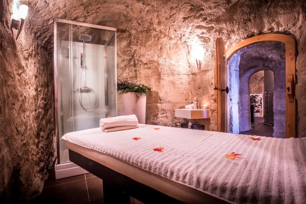 a bedroom with a shower and a bed in a room at Le Grand Aigle Hotel & Spa**** in La Salle-les-Alpes