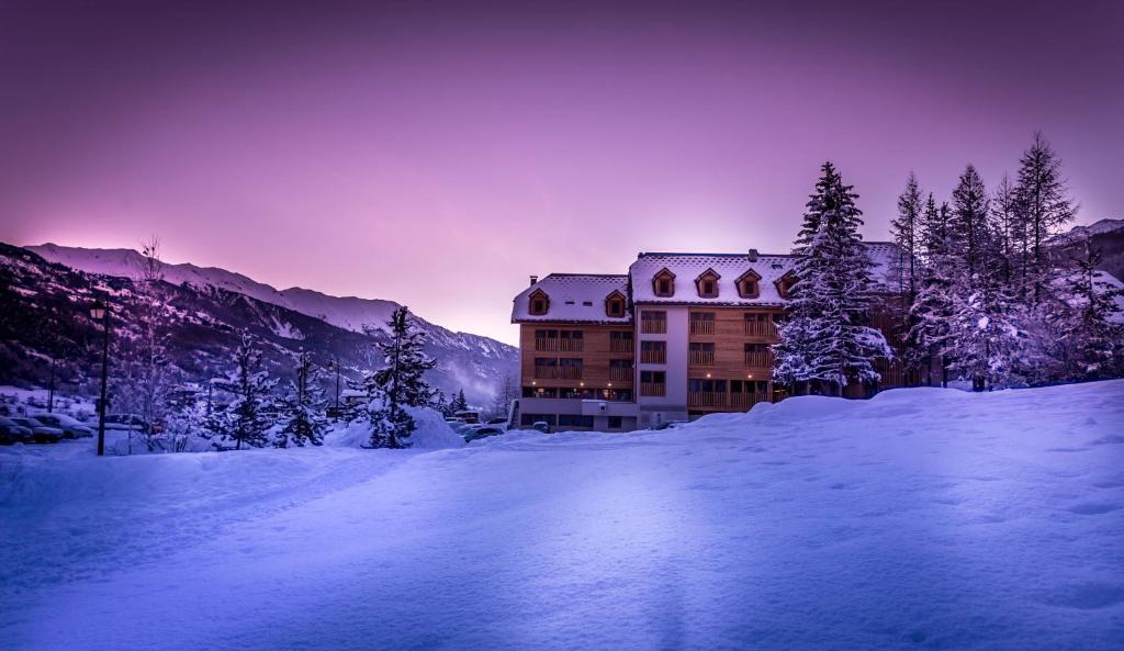 a building in the middle of a snow covered mountain at Le Grand Aigle Hotel & Spa**** in La Salle-les-Alpes