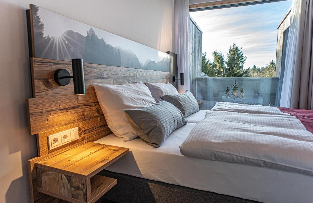 a bedroom with a bed and a large window at Pension Sewald in Berg