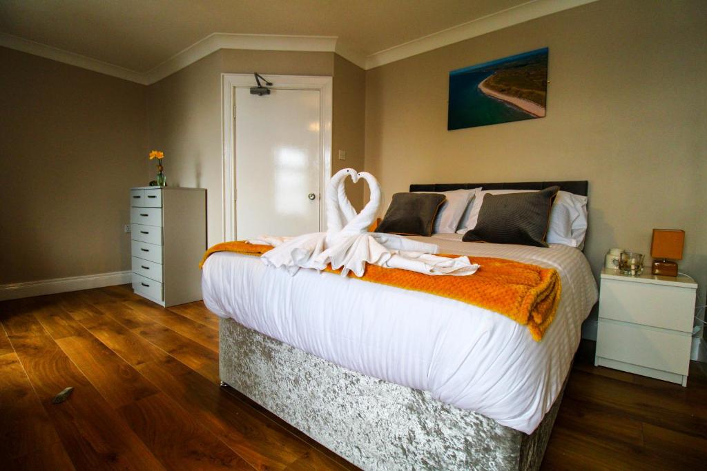 a bedroom with a large bed with a white bird on it at Beulah Guest House in Portrush
