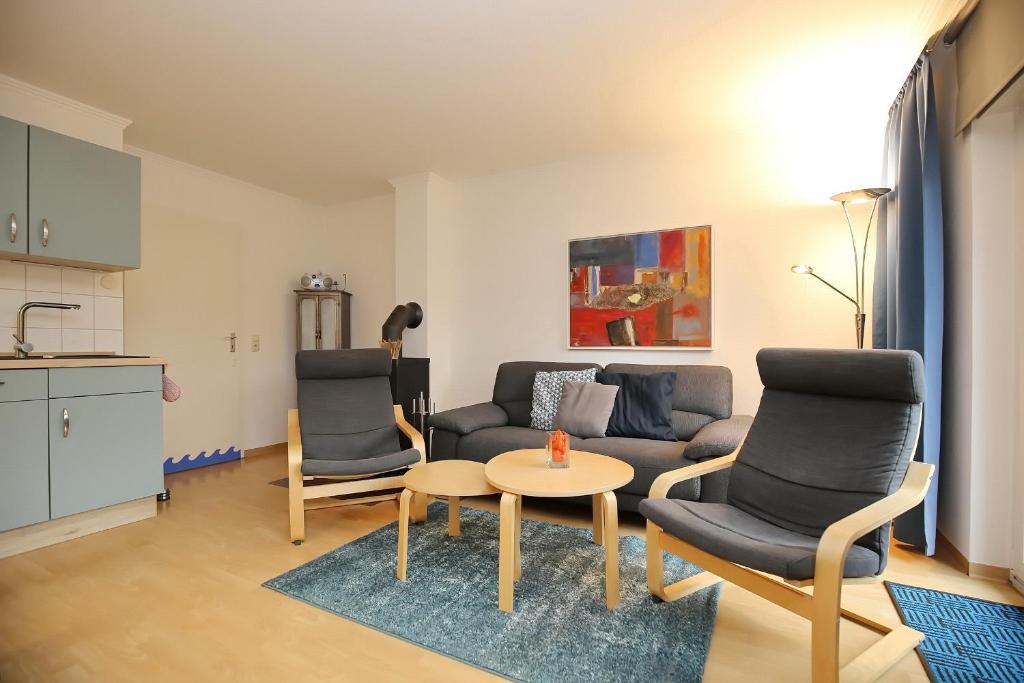 sala de estar con sofá, 2 sillas y mesa en Urlauberdorf Haus 22c, en Boltenhagen