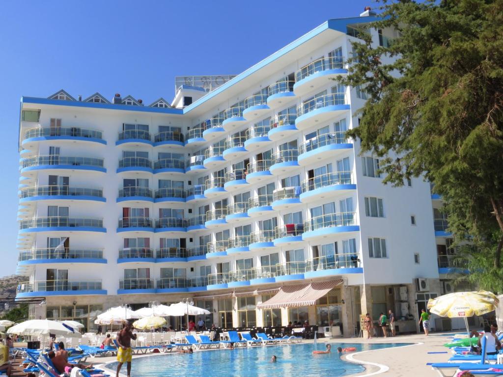 a large white hotel with a swimming pool at Arora Hotel in Kusadası