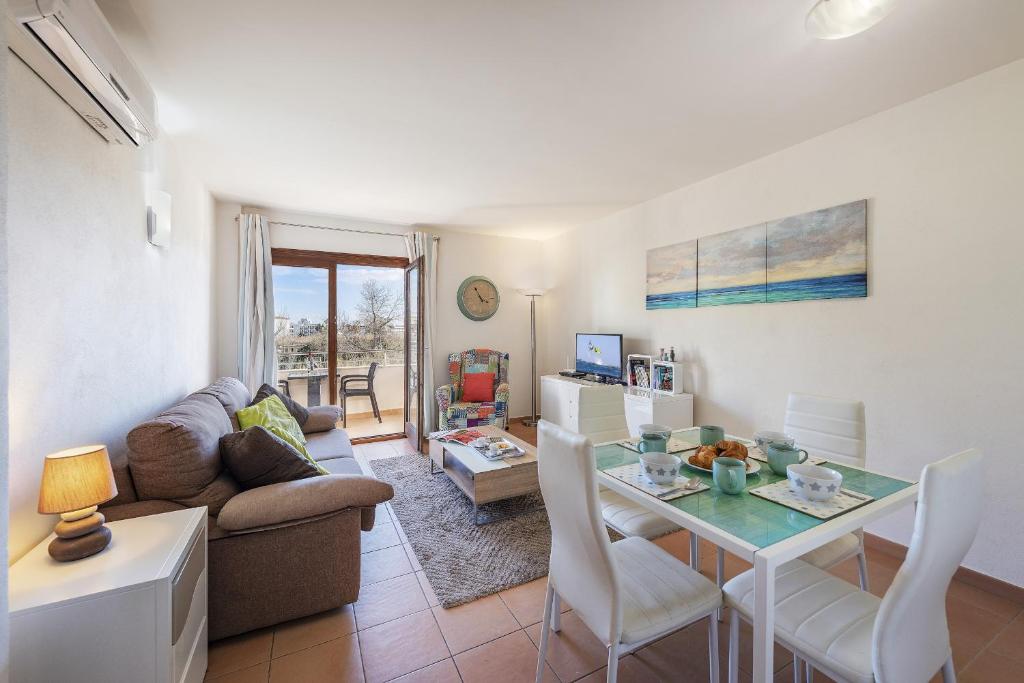 a living room with a table and a couch at Apartment Corb Mari in Port de Pollensa
