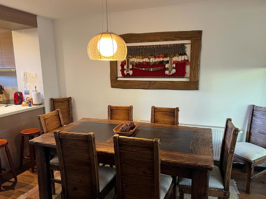 a dining room with a wooden table and chairs at PUCON HOUSE - Lake Access & Near Ski Center in Pucón