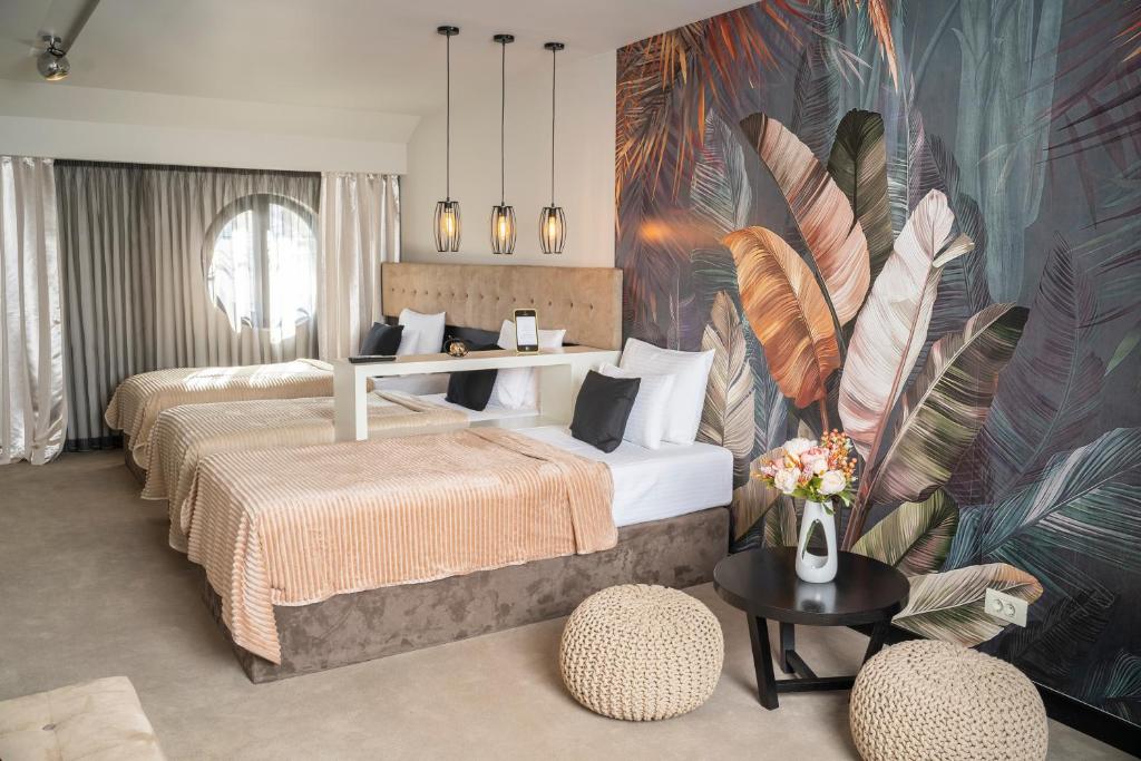 a bedroom with two beds and a mural of feathers at Akacija Luxury Suites- Zemunski kej in Belgrade