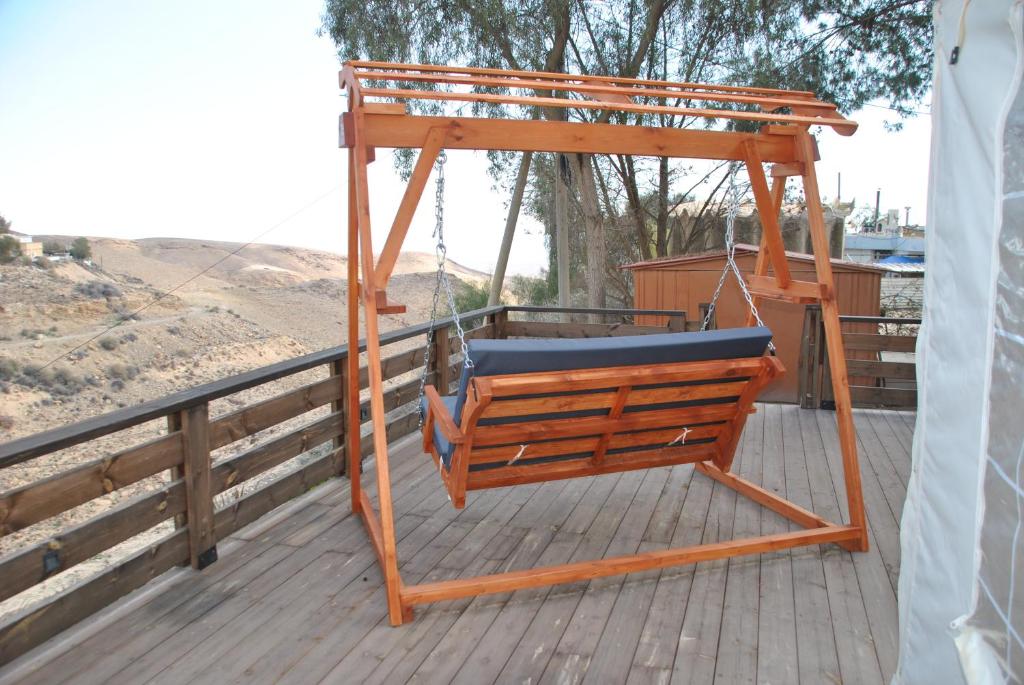 a swing on the deck of a house at Marvin's Place in Arad