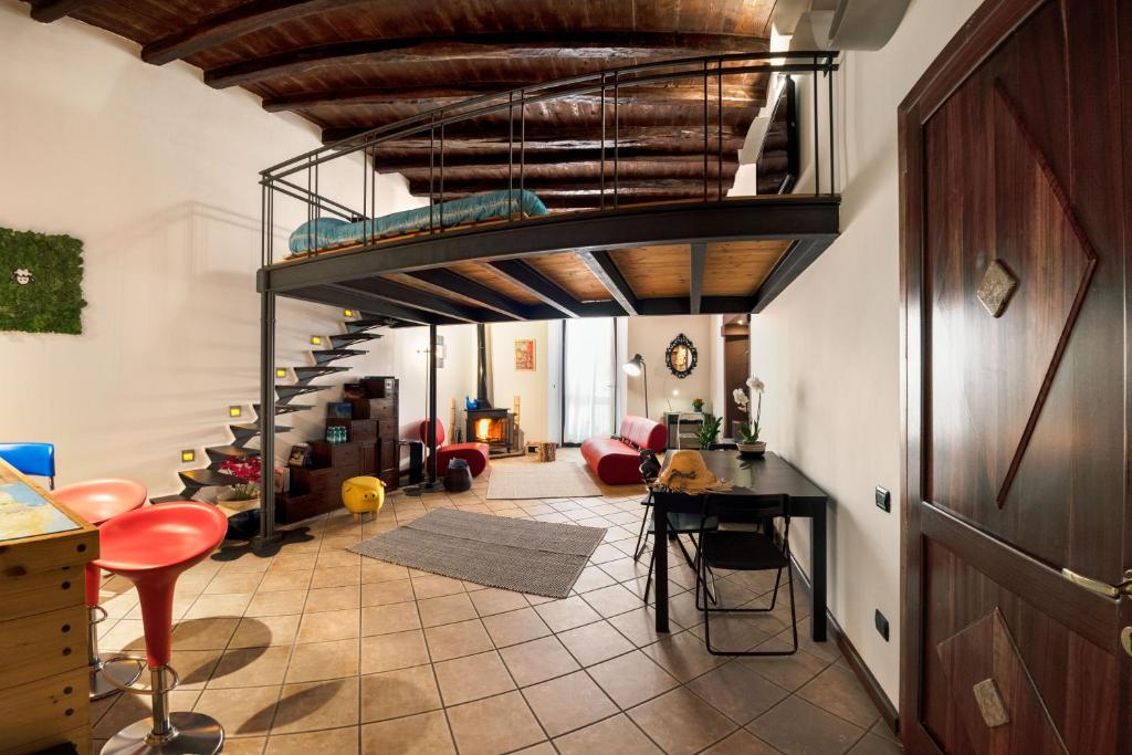 a living room with a spiral staircase in a house at Casa Kawaii in Cagliari