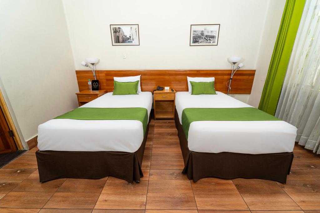 Postel nebo postele na pokoji v ubytování Hotel El Turista
