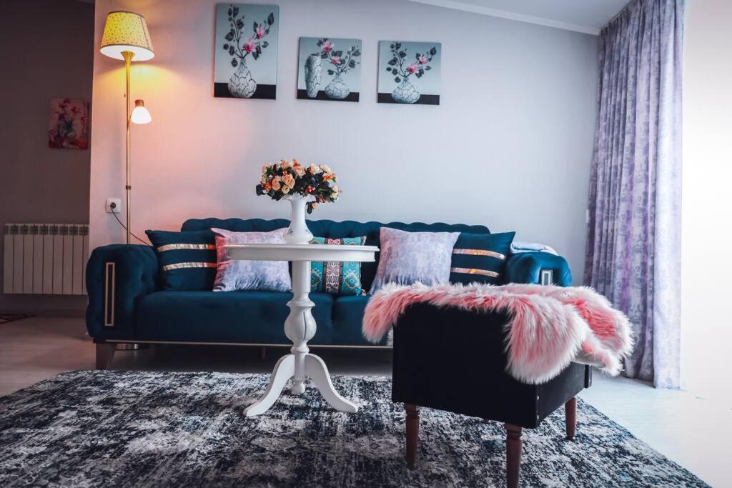 a living room with a blue couch and a table at Lika's apartment in Old Tbilisi in Tbilisi City