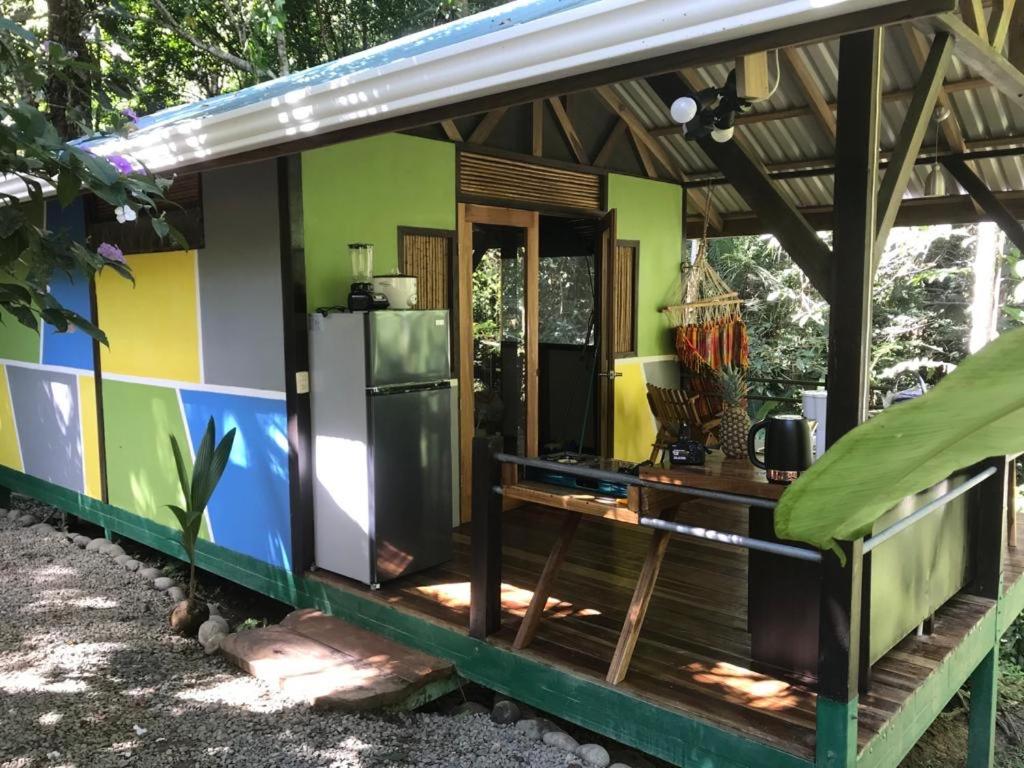 a small house with a refrigerator and a table at Pequeño Paraiso 1 in Punta Uva