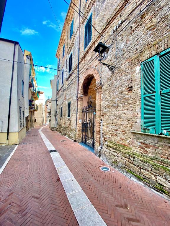 an empty street with a brick building and an alley at Bella Vista in Ortona