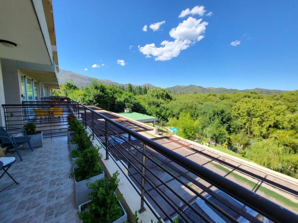 a balcony with a view of the train tracks at Altos del Potrero Apart in Potrero de los Funes