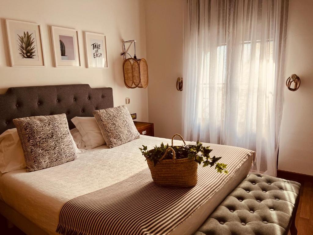 a bedroom with a bed with a basket on it at Casa Ruy Lopez in Zafra