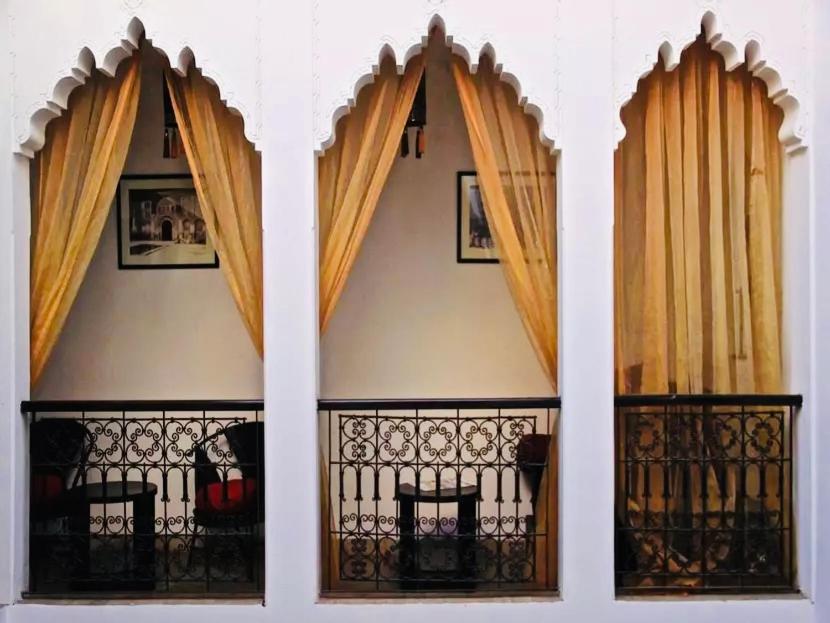 a room with a window with curtains and a fence at Riad La Residenza in Marrakesh