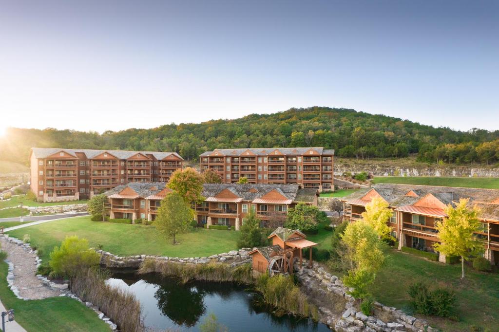 a park with a lake and a large building at The Lodges at Timber Ridge by Vacation Club Rentals in Branson