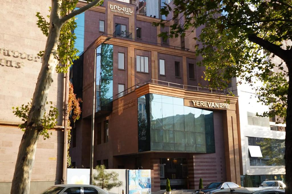 a building with a sign on the front of it at Yerevan Resident Hotel in Yerevan