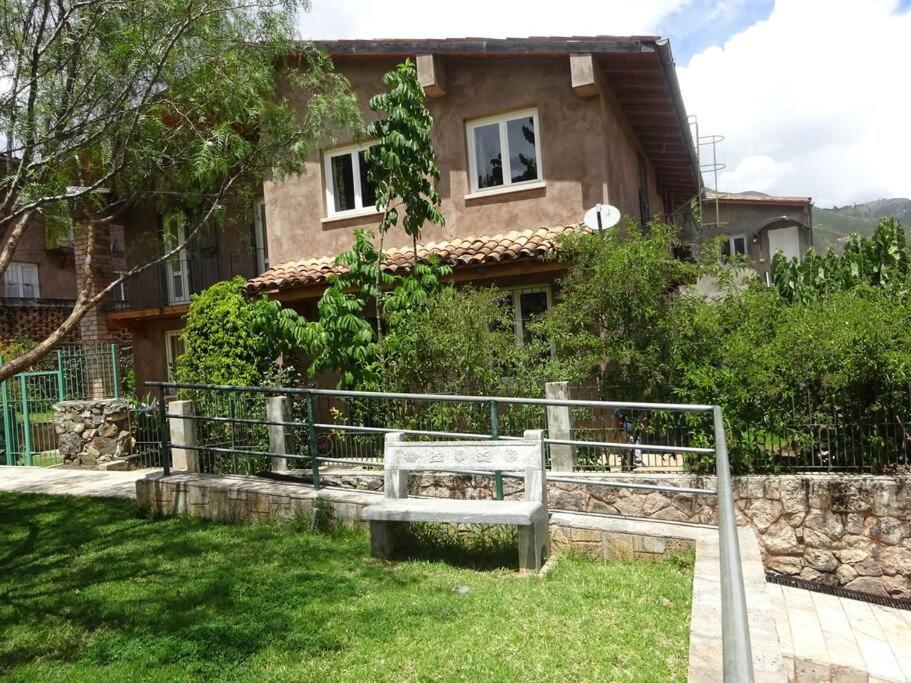 a house with a bench in front of it at Taulli Guest in Marcará