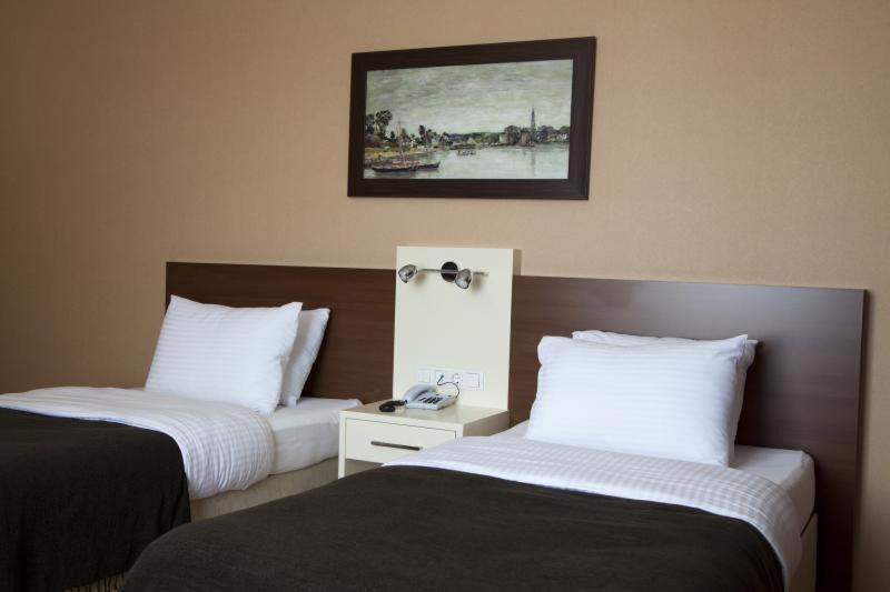Postel nebo postele na pokoji v ubytování Gosterisli Otel