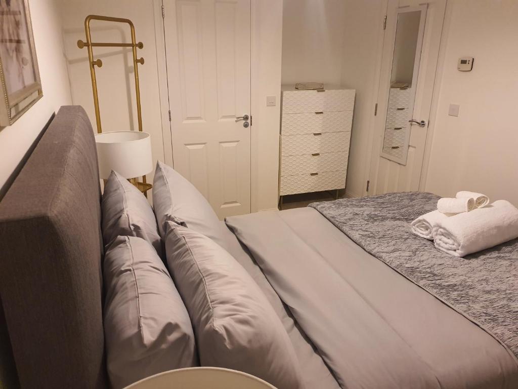 a bedroom with a bed with pillows on it at The Joyland Residential Home in Romsey