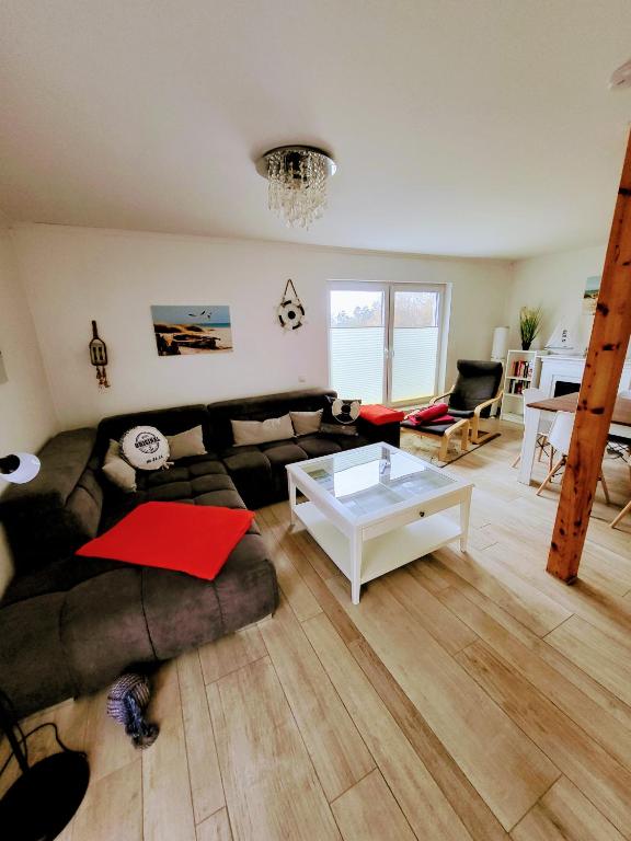 a living room with a couch and a table at Ferienwohnung Walfisch inkl Strandkorb in Göhren