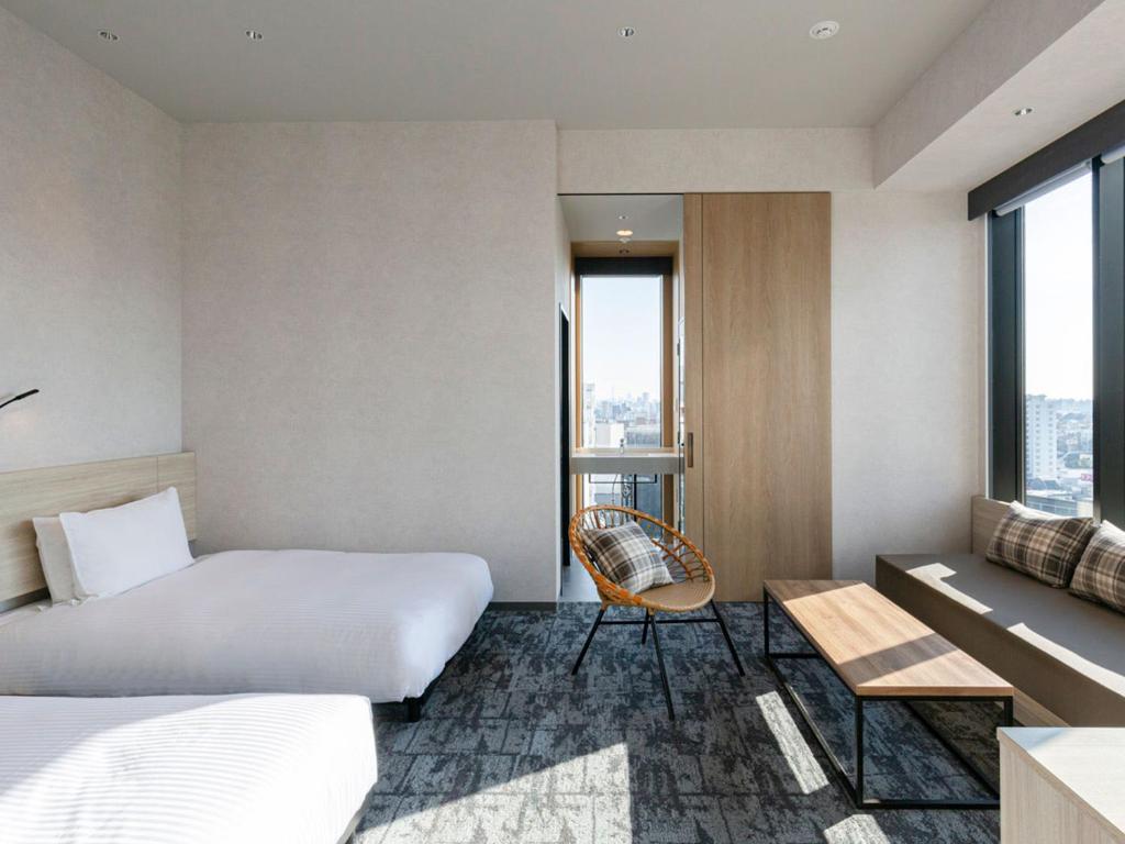 Postel nebo postele na pokoji v ubytování Akabane Holic Hotel