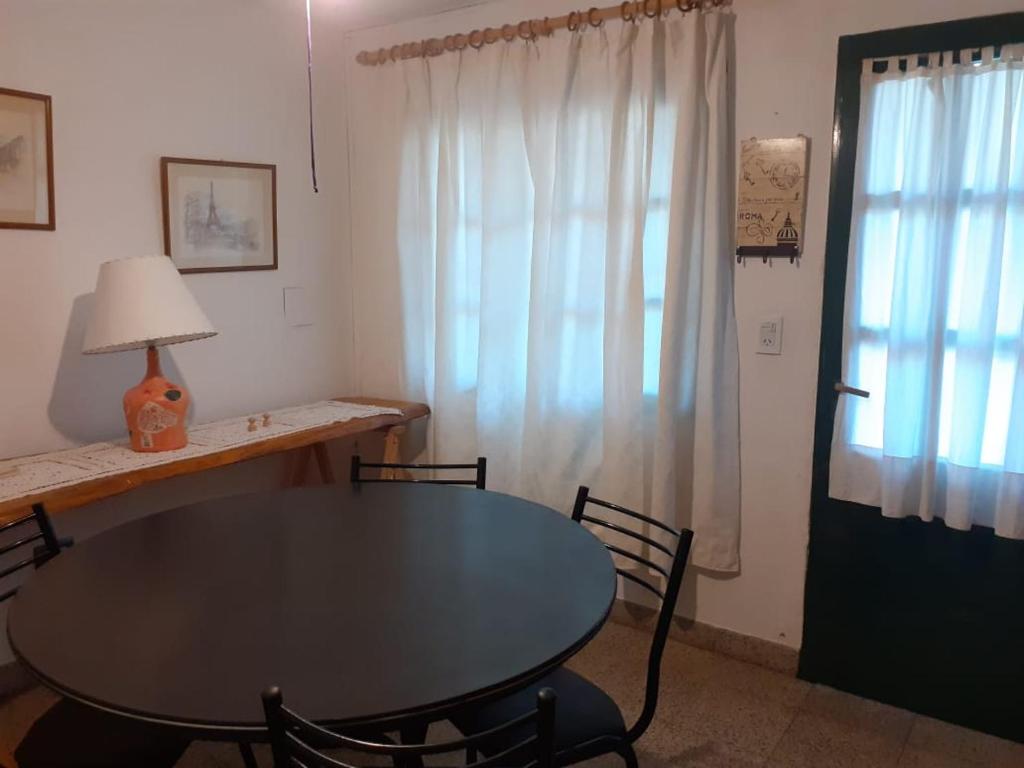 a dining room with a table and chairs and a window at SOL Y LUNA in Huerta Grande